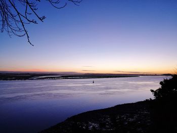 Scenic view of sea against clear sky during sunset