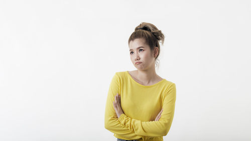 Portrait of beautiful young woman against white background