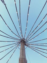 Low angle view of ferris wheel against clear blue sky