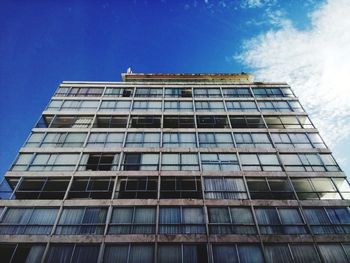 Low angle view of modern building against blue sky