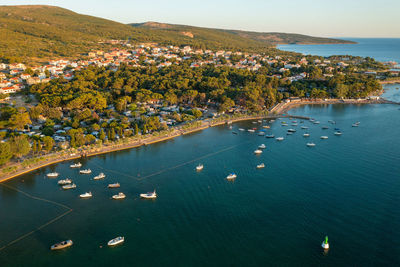 High angle view of townscape by sea against sky