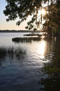 Scenic view of lake against sky at sunset