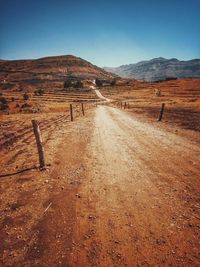 Surface level of country road against cloudy sky
