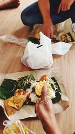 Cropped hand of person preparing food that call pecel