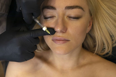 Close-up of woman applying make-up