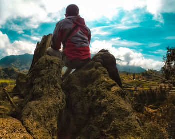 Low angle view of man on mountain against sky