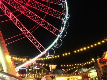 Low angle view of illuminated ferris wheel at night