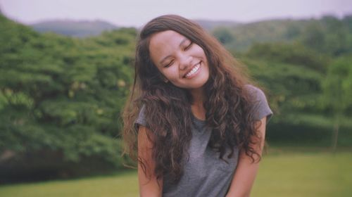 Smiling young woman standing outdoors