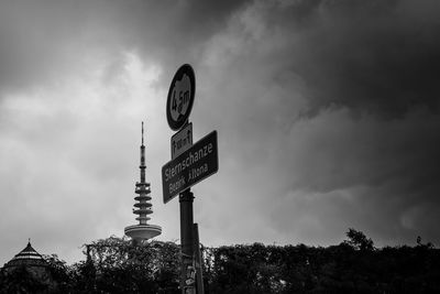 Low angle view of road sign against sky
