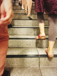 Low section of women walking on staircase