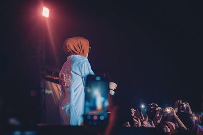 People enjoying music concert at night