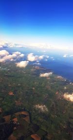 Aerial view of agricultural field against blue sky