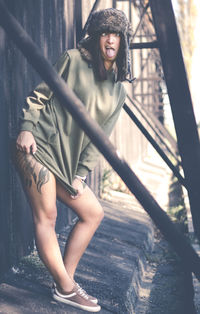 Portrait of smiling young woman standing outdoors