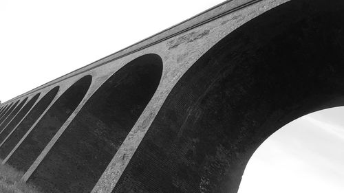 Low angle view of arch bridge against sky