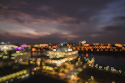 Illuminated city against sky at night