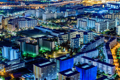 High angle view of illuminated buildings in city at night