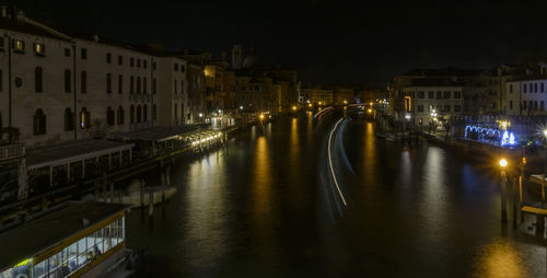 Canal passing through city at night