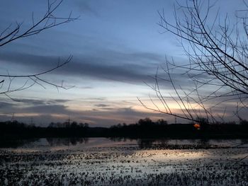 Scenic view of lake against sky at sunset