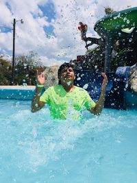 Full length of happy boy in swimming pool