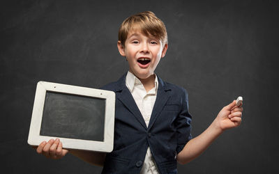 Portrait of young man with arms outstretched