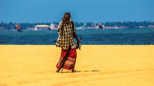 Rear view of woman standing on beach