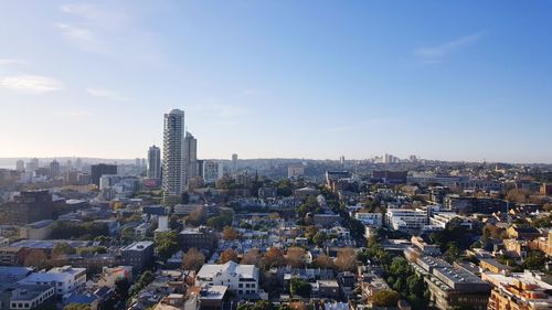 Aerial view of buildings in city against sky