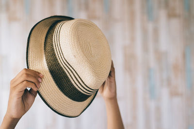 Boy holding hat