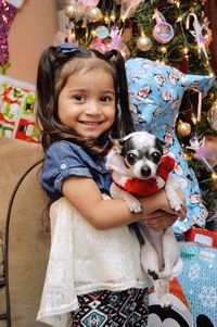 Portrait of cute girl with puppy