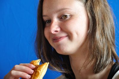 Close-up portrait of a woman eating food