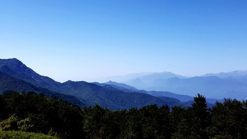 Scenic view of mountains against clear blue sky