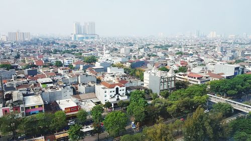 High angle view of buildings in city against sky