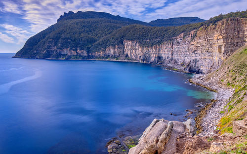 Scenic view of sea and mountains against sky