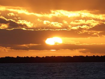 Scenic view of sea against orange sky