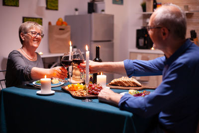 Young woman having food at home