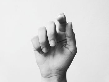 Close-up of human hand against white background