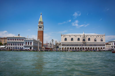 View of buildings by canal against sky in city in venice