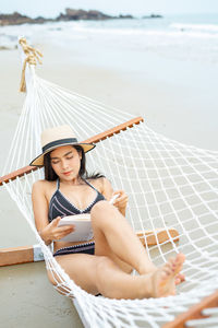 Young woman sitting on beach