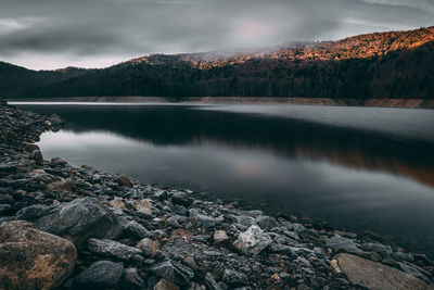 Scenic view of lake and mountains against sky