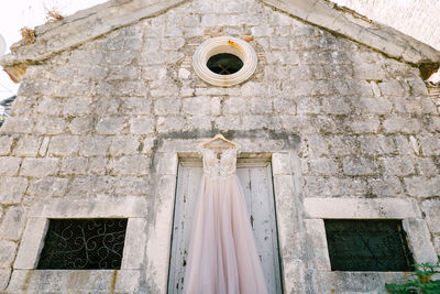 Low angle view of cross on building wall