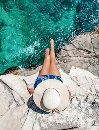 High angle view of woman lying down in swimming pool