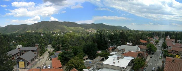 Panoramic view of buildings in city against sky