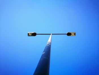 Low angle view of lamp against clear blue sky