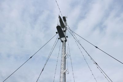 Low angle view of crane against sky