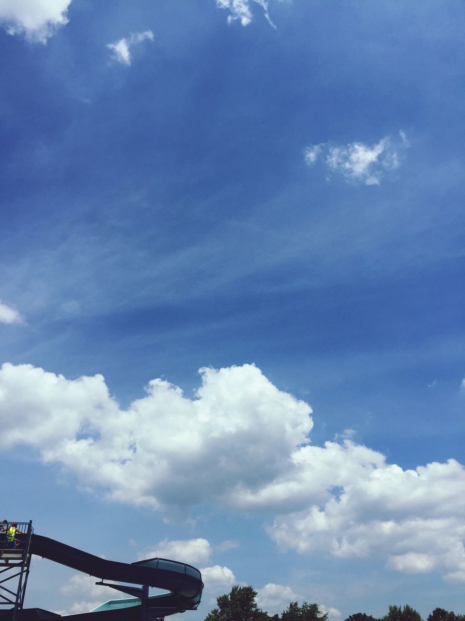 low angle view, sky, cloud - sky, blue, cloudy, cloud, beauty in nature, tranquility, nature, scenics, tranquil scene, outdoors, day, sunlight, no people, silhouette, tree, idyllic, connection, weather