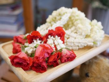 Close-up of fresh red roses on table