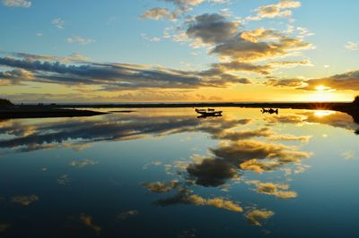 Reflection of clouds in water at sunset