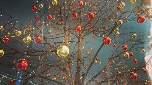 Low angle view of christmas decoration hanging against sky