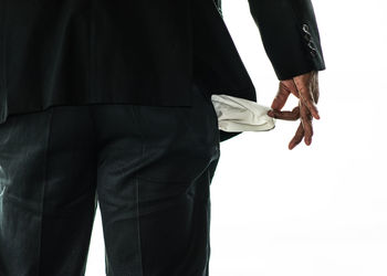 Rear view of man standing against white background