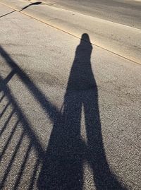 Shadow of person on road