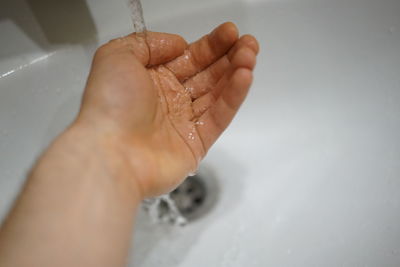 Close-up of person hands in bathroom